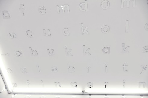 between (legs), 2016, levitating white cube filled with a crossword of porn tags